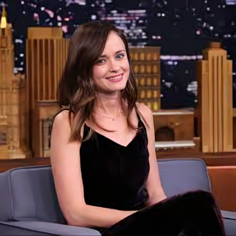 Alexis Bledel is sitting on the couch